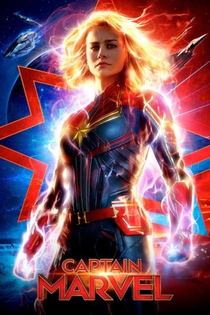 Brie Larson glowing gold and blue, hair alight, arms out, a starfield behind her.