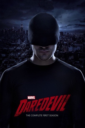 Charlie Cox in a black mask and dark clothes, head bowed, against a dim city skyline.