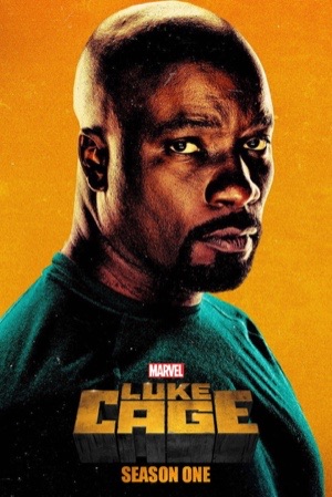 Mike Colter in a bullet-holed hoodie against a bright orange background.